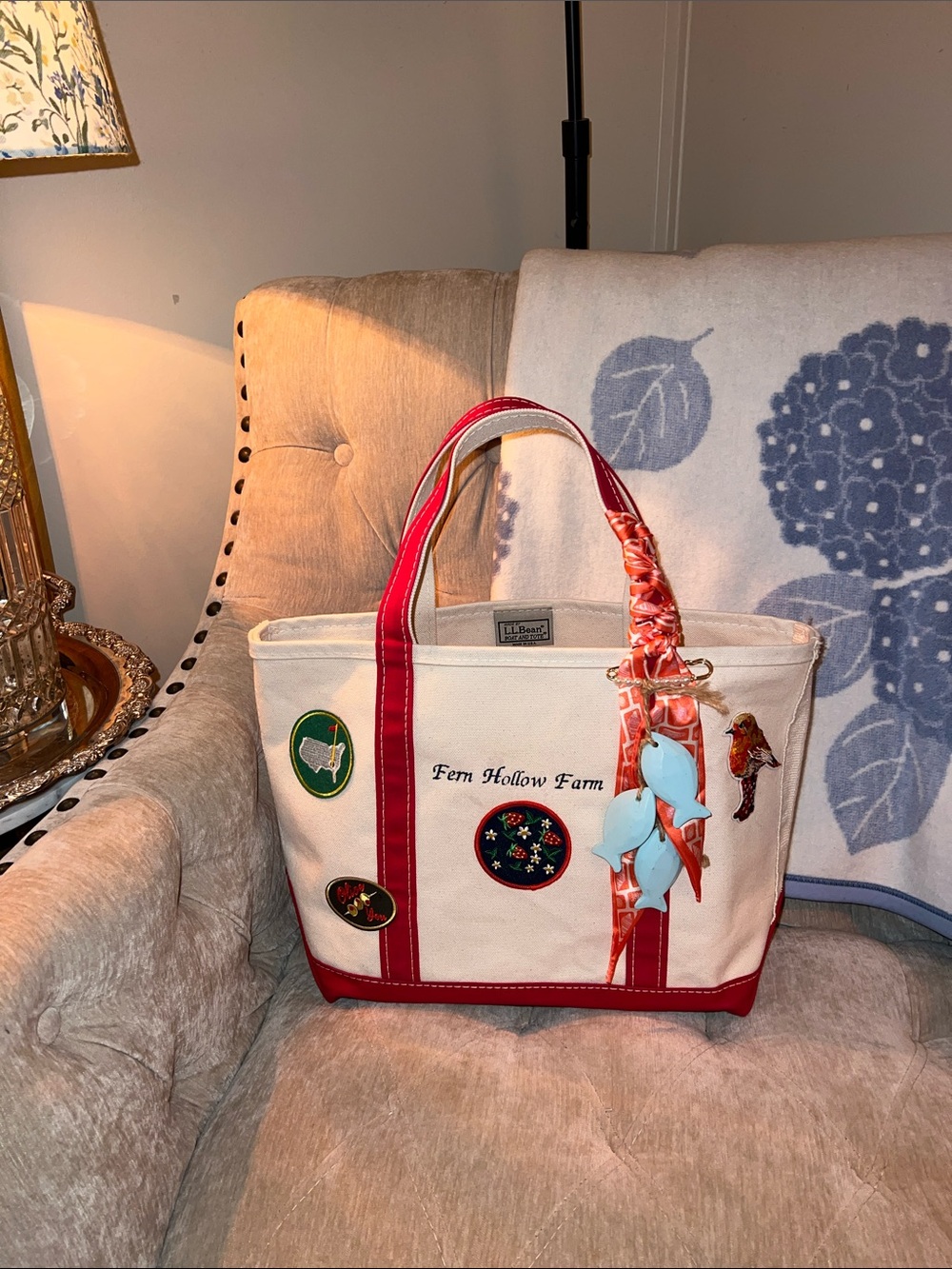 L.L. Bean Cream Canvas Tote with Red Trim and Blue Fish Charm. Bag sold as is
